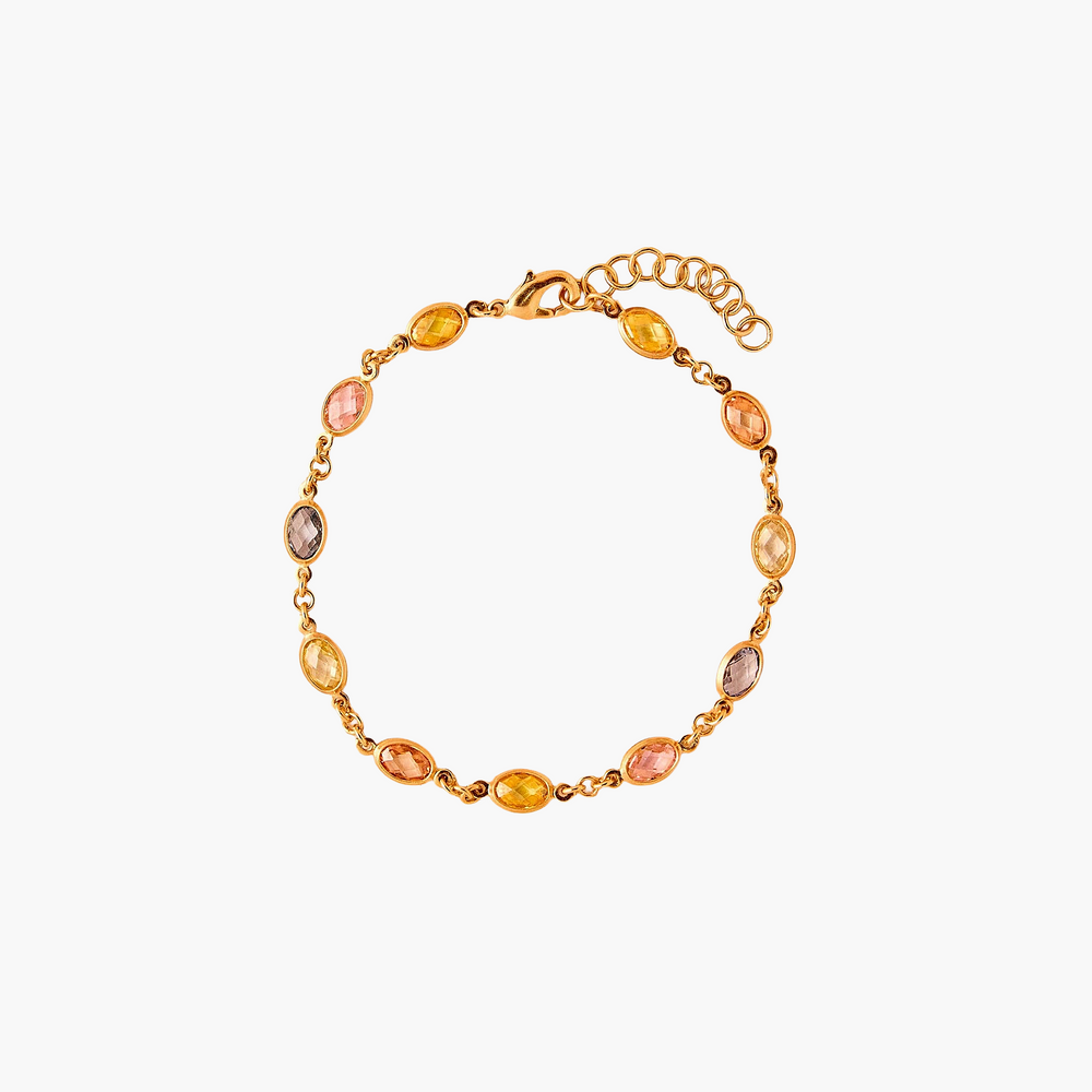 Gold bracelet with multicolored beads on a white background