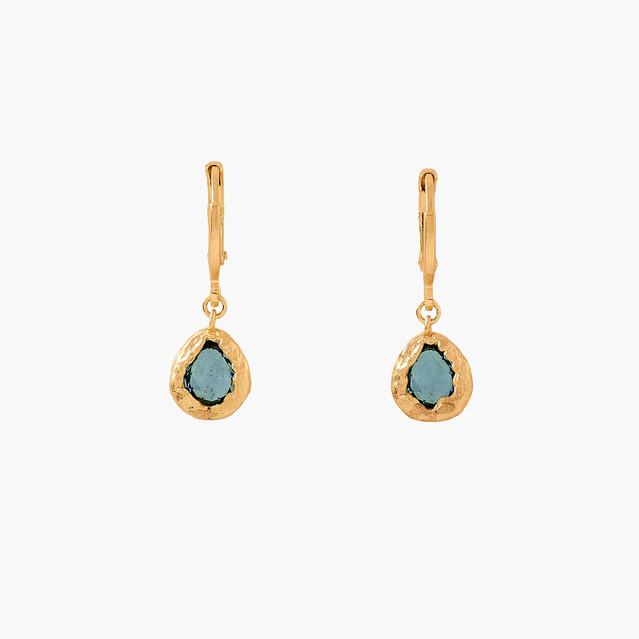 Gold earrings with green gemstones on a white background