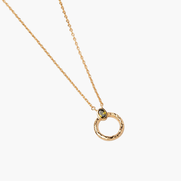 Gold necklace with a circular pendant on a white background