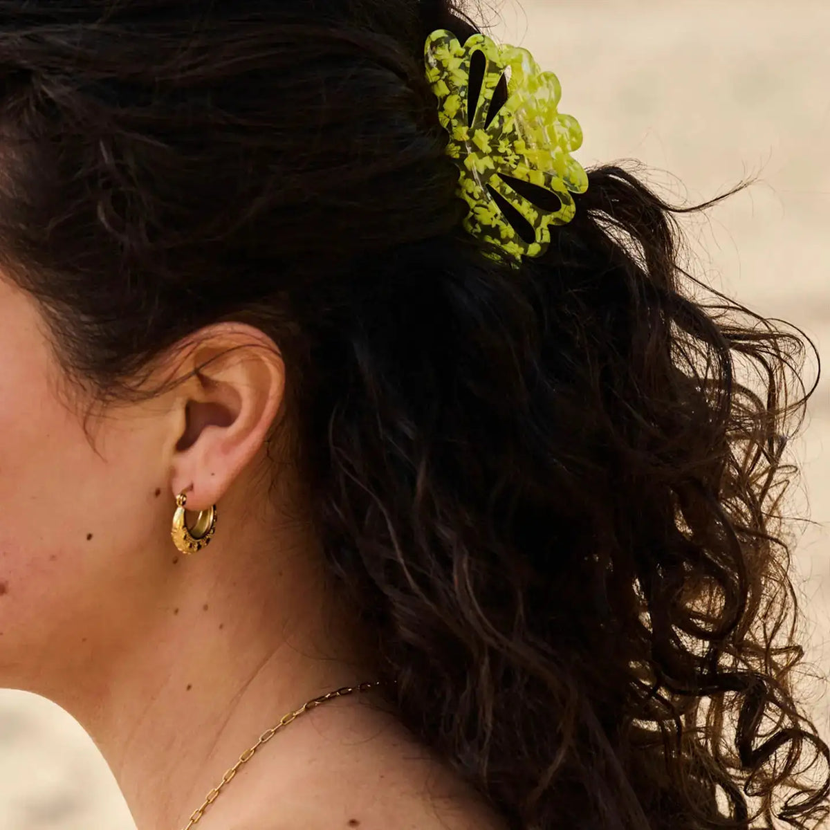 Bright yellow hair clip for women with a playful elegant design, perfect for everyday hairstyles