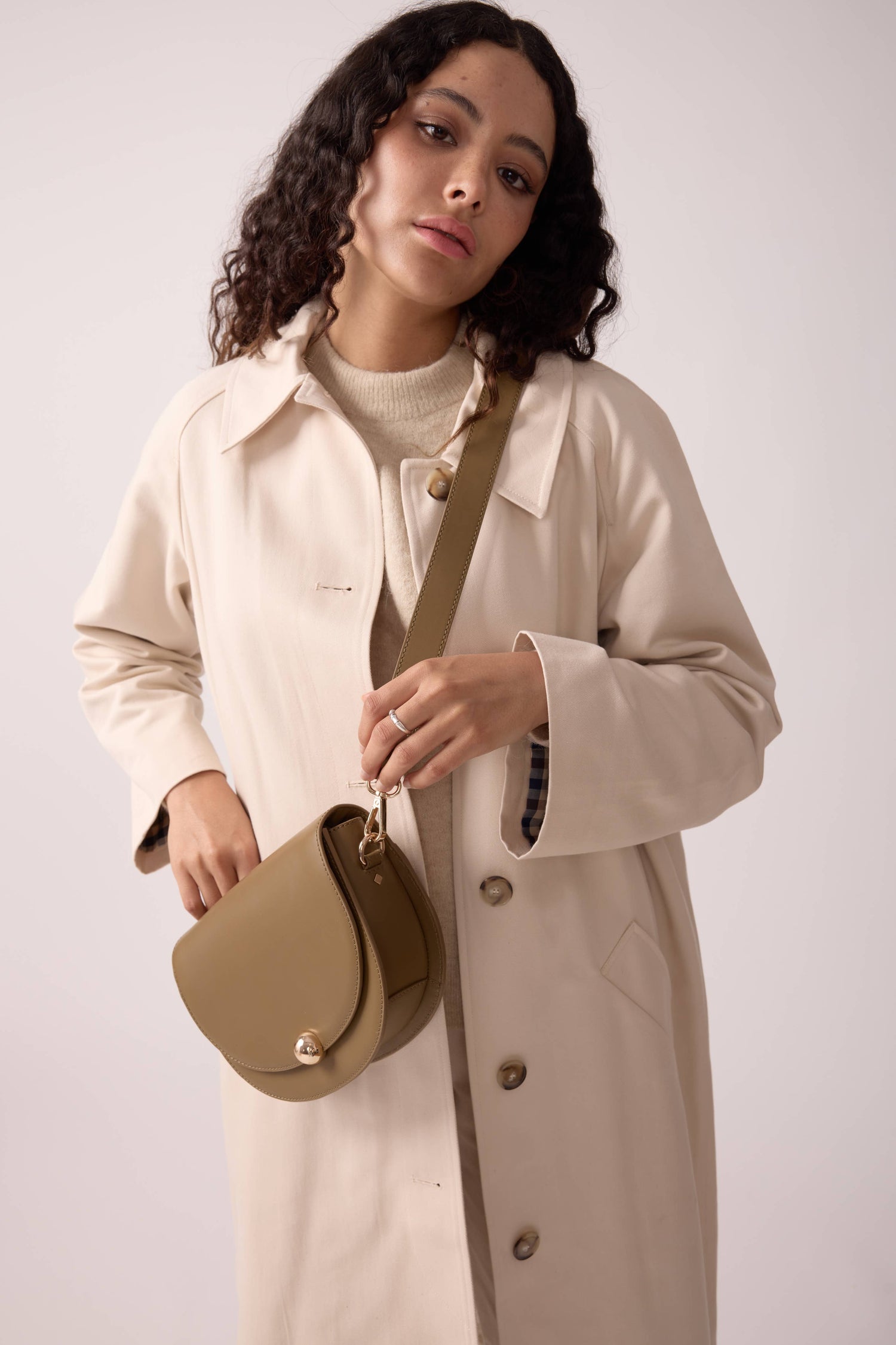 Elegant Maradji Noa bronze leather baguette shoulder bag, handcrafted with a unique crescent shape