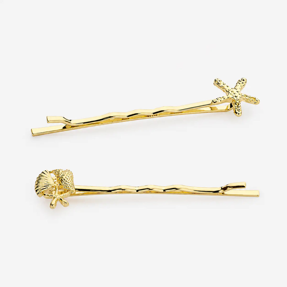 Elegant gold-plated hair clip featuring a sophisticated ocean-inspired design and coastal aesthetic
