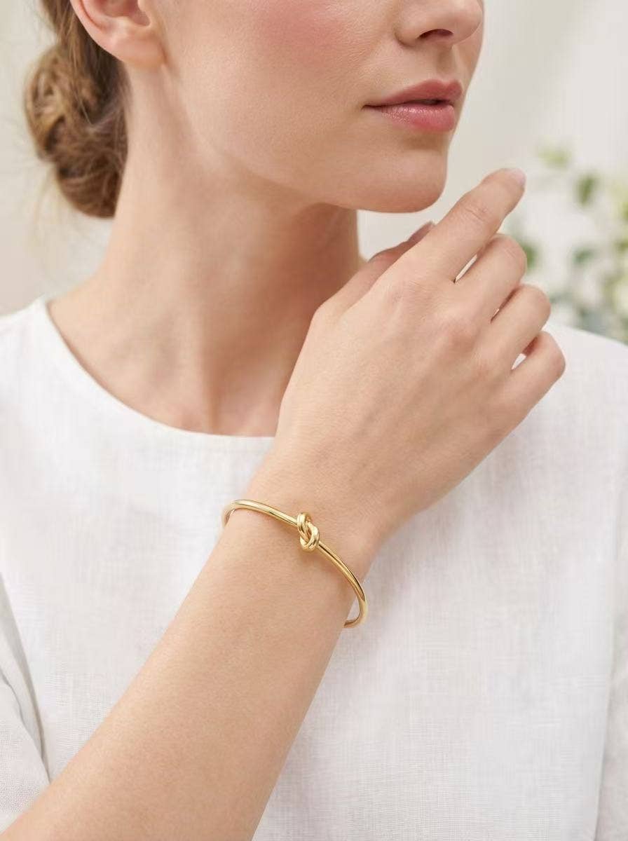 Elegant gold knot bracelet crafted from stainless steel with a water-resistant finish for everyday styling