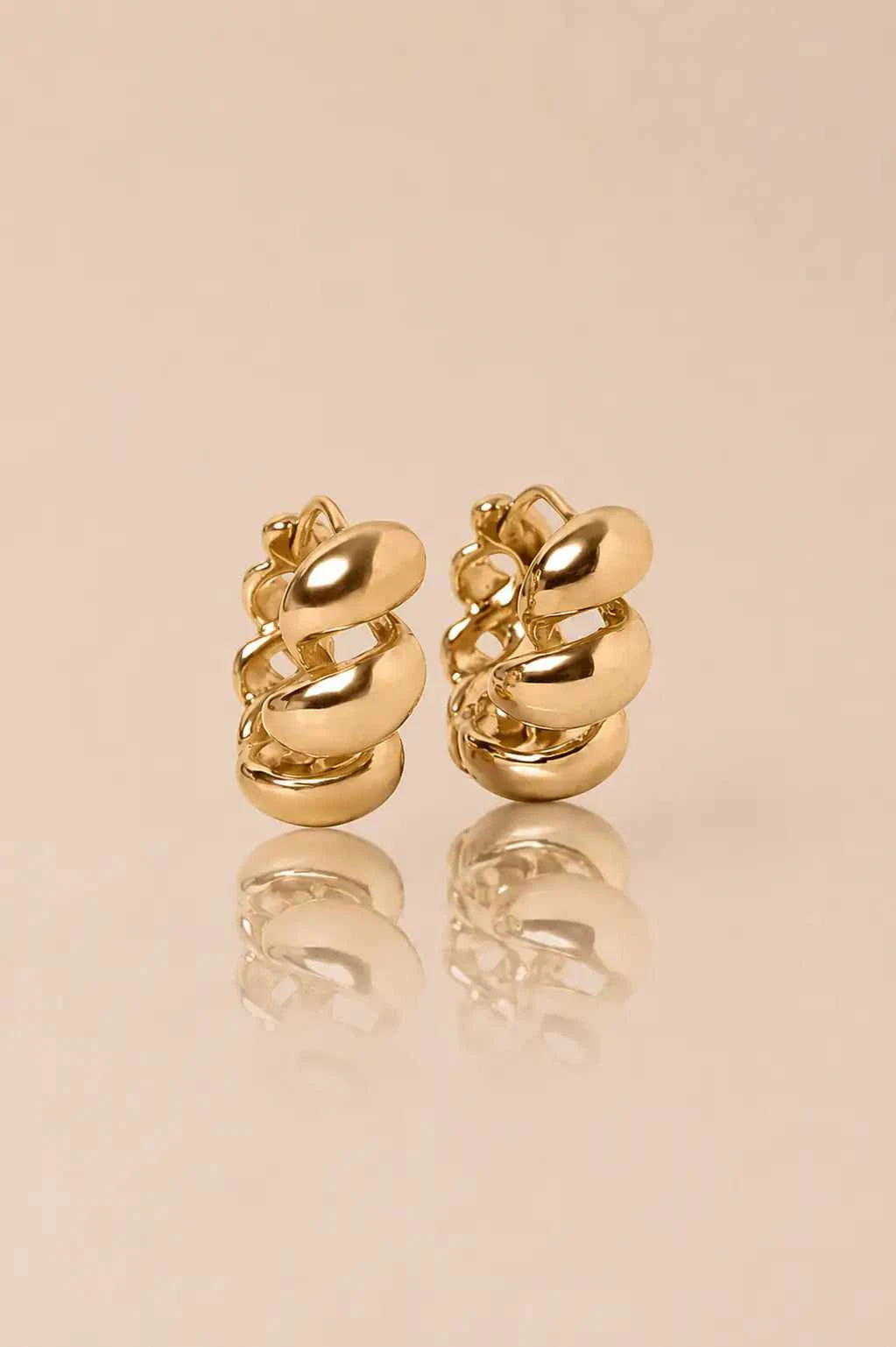 Elegant ISEL gold-tone statement earrings featuring a sophisticated and timeless design