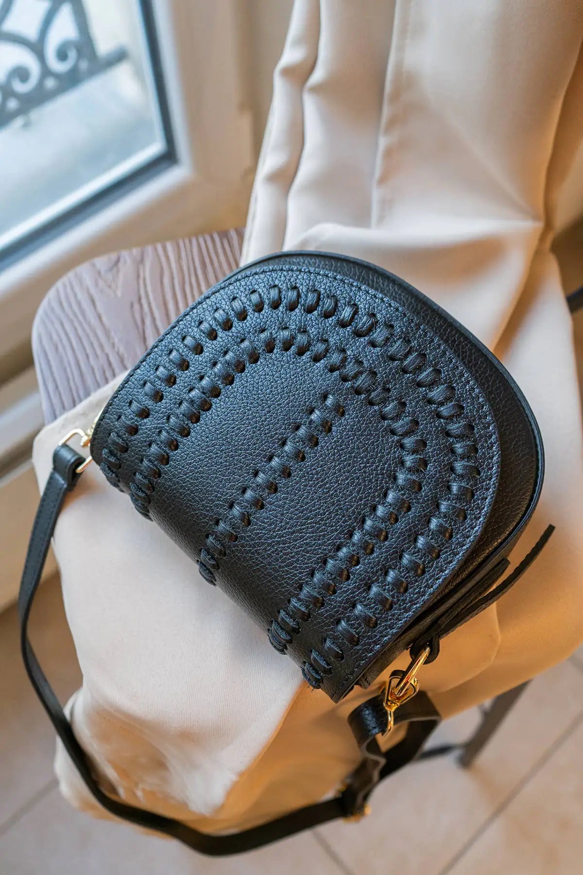 Grained Luxe leather crossbody handbag featuring premium textured leather and a refined contemporary silhouette