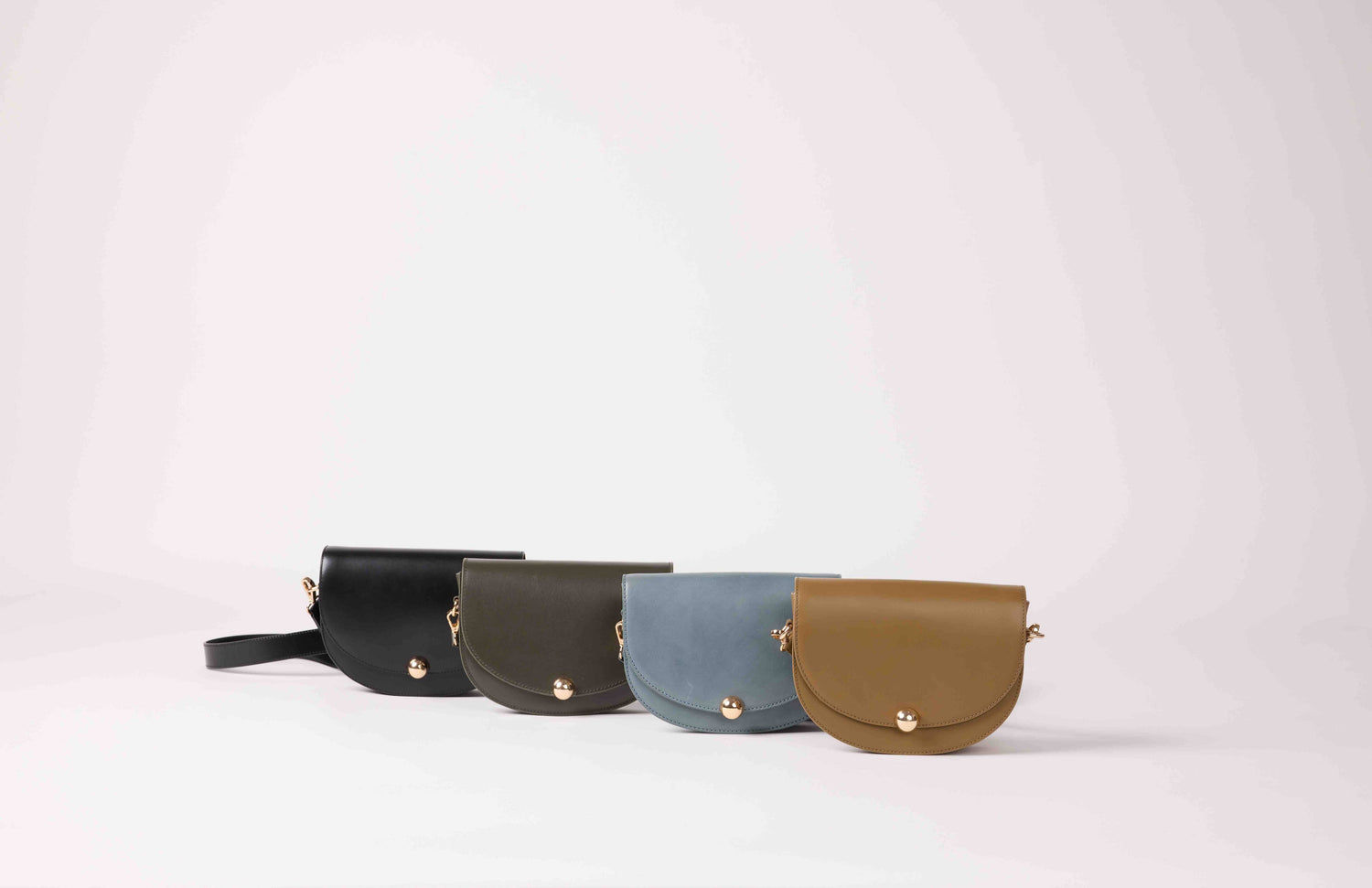 Handcrafted bronze leather baguette shoulder bag by Maradji Noa with a refined crescent silhouette