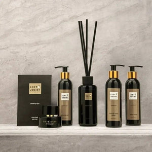 Liet & Joliet Sparkling Night Hand & Body lotion set with diffusers on a marble surface.