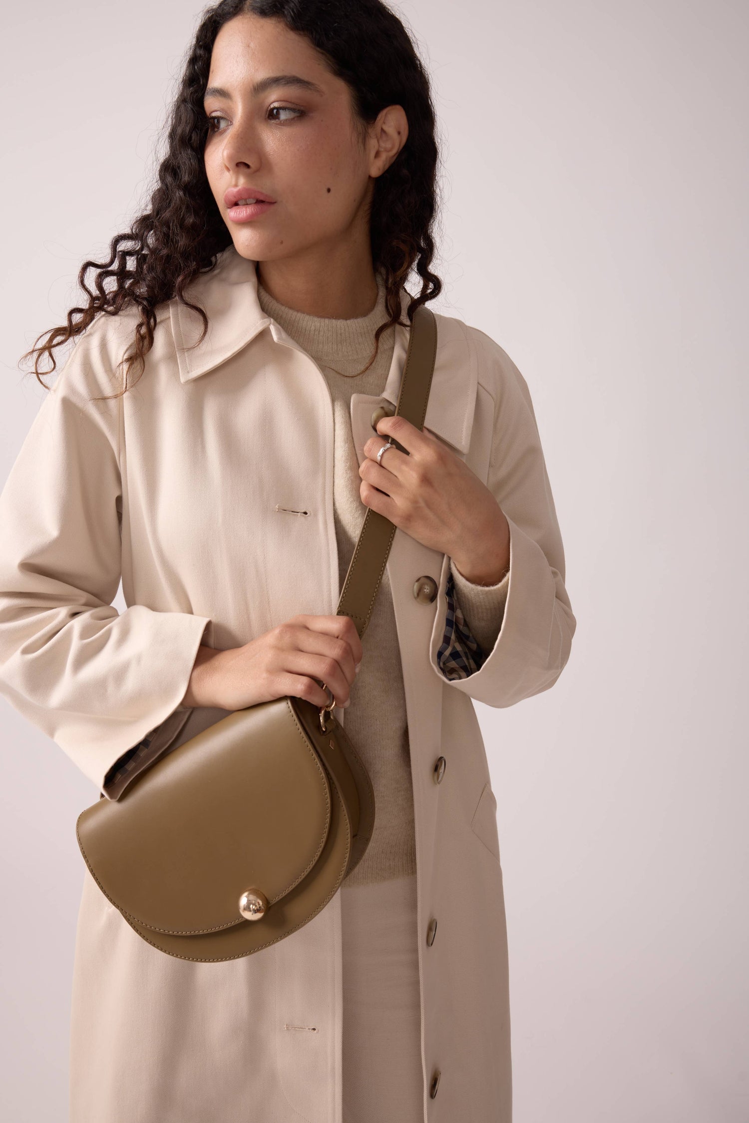 Luxury bronze leather Maradji Noa baguette bag with handcrafted crescent silhouette and shoulder strap