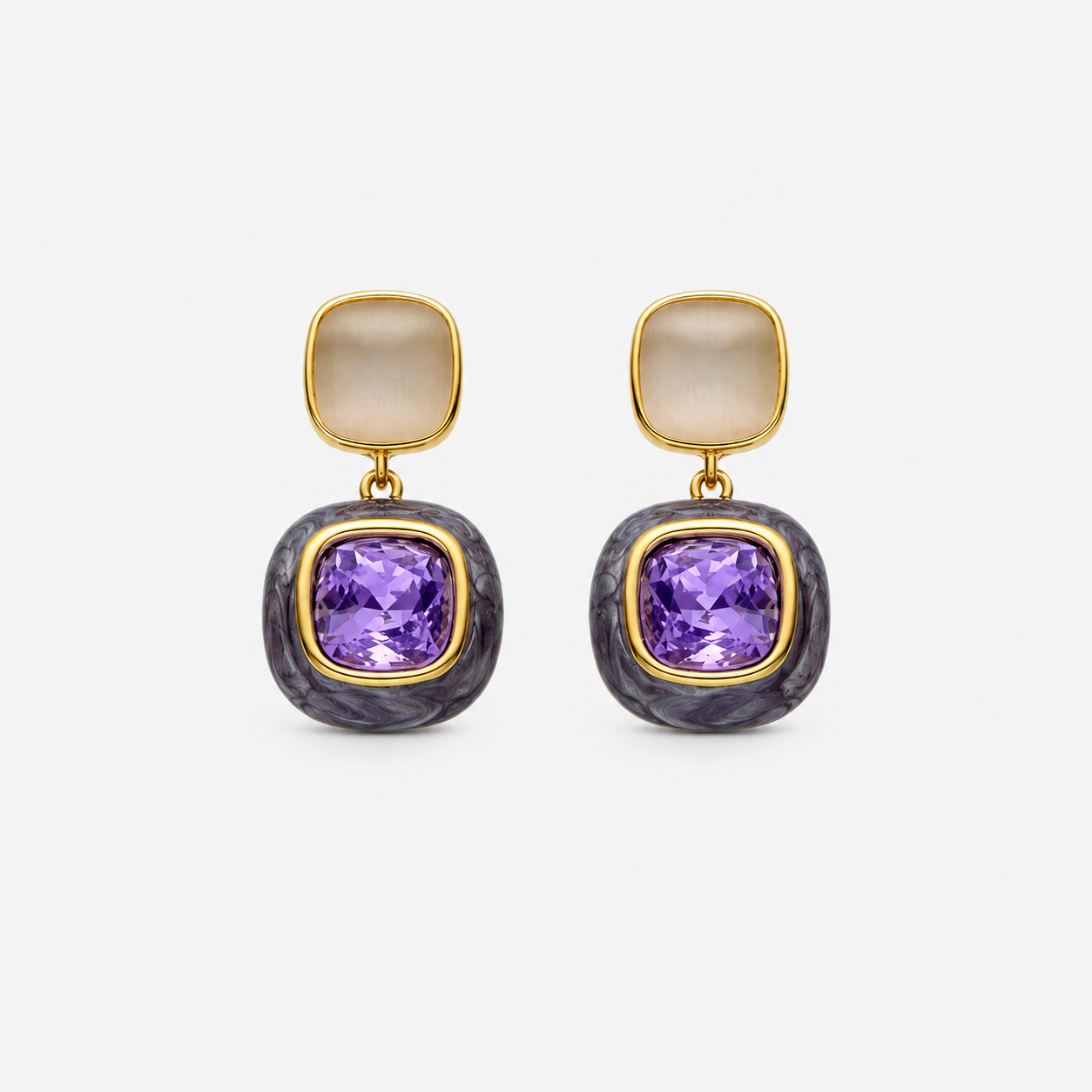 Pair of earrings with purple gemstones and gold accents on a white background