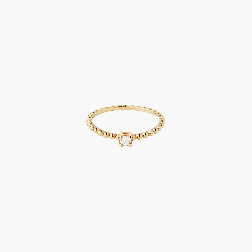Gold ring with a small diamond on a white background