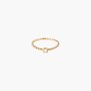 Gold ring with a small diamond on a white background