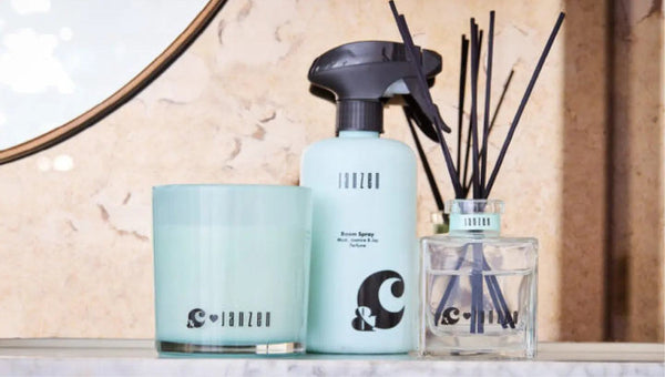 Janzen Room Spray, Musk Jasmine & Joy, 500ML bottle on a shelf with a candle and diffuser.