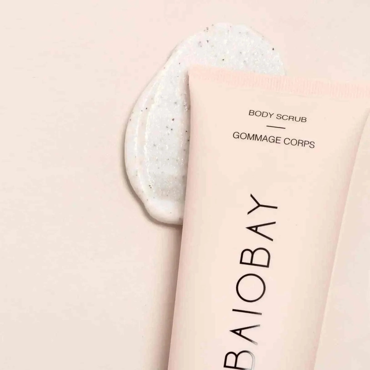 Baiobay Bodyscrub Coconut and Vegan creamy white body scrub with natural exfoliating particles displayed next to a blush pink tube