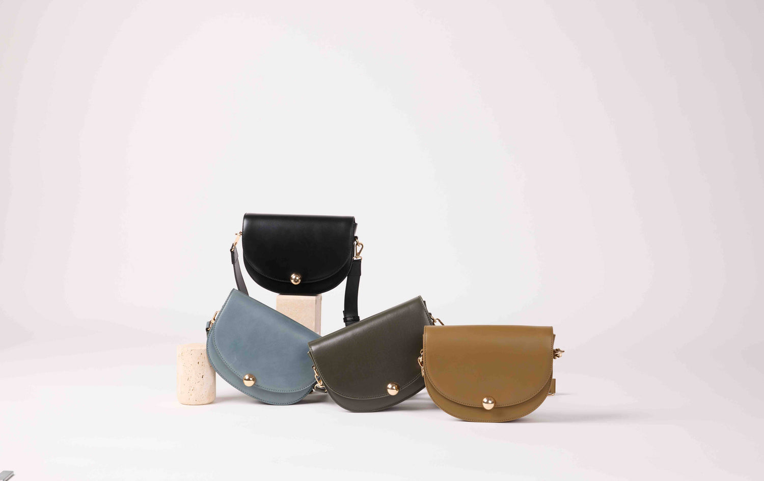 Bronze Maradji Noa leather shoulder baguette bag featuring a curved crescent shape and handmade craftsmanship