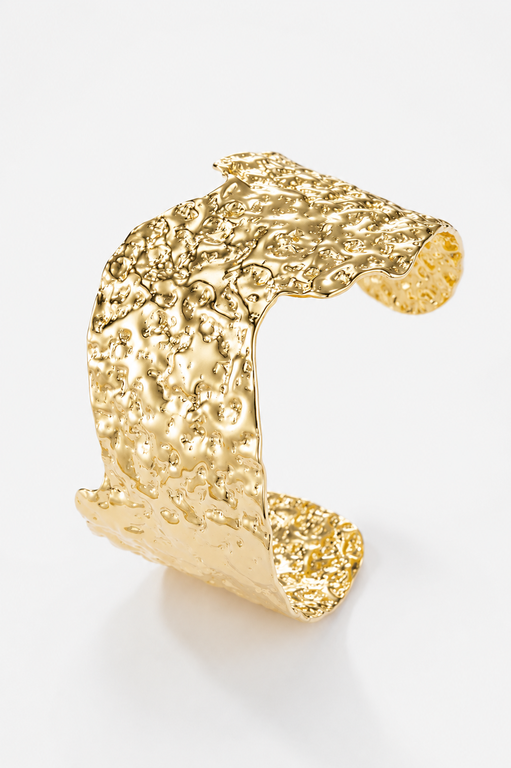 Gold textured ring on a white background