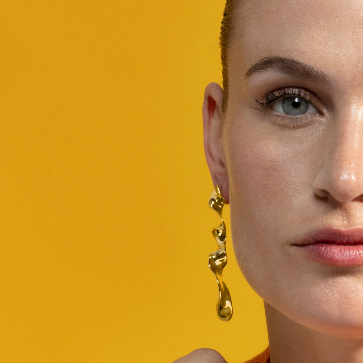 Gold geometric drop statement earrings by Triye with a refined contemporary design and stylish silhouette