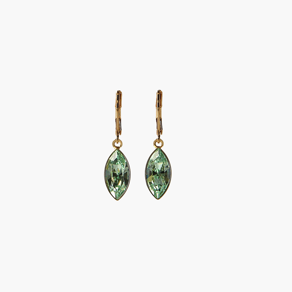 Gold earrings with green gemstones on a white background