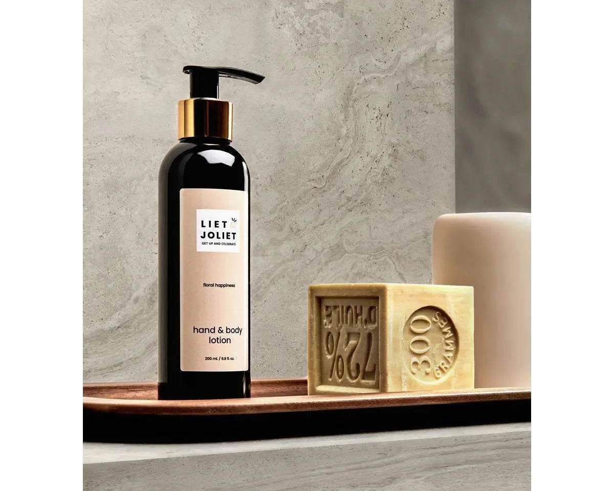 Liet & Joliet Floral Happiness Hand & Body lotion on bathroom counter with minimalist decor.