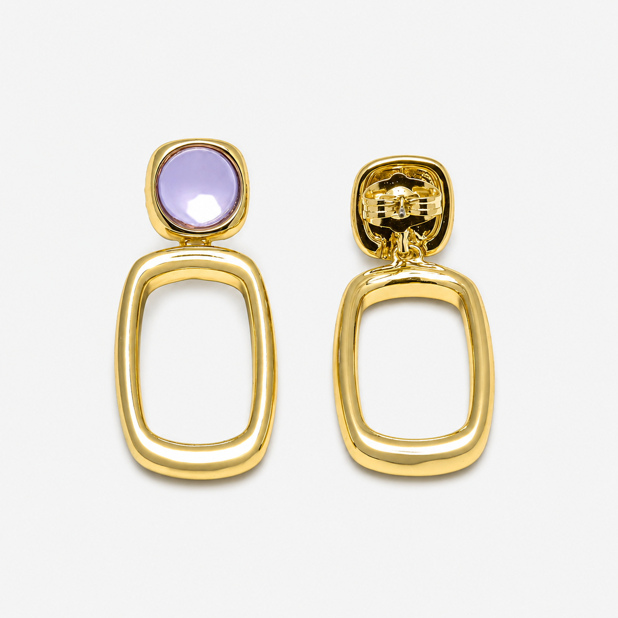 Gold earrings with a purple gemstone on a white background