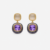 Pair of earrings with purple gemstones and gold accents on a white background