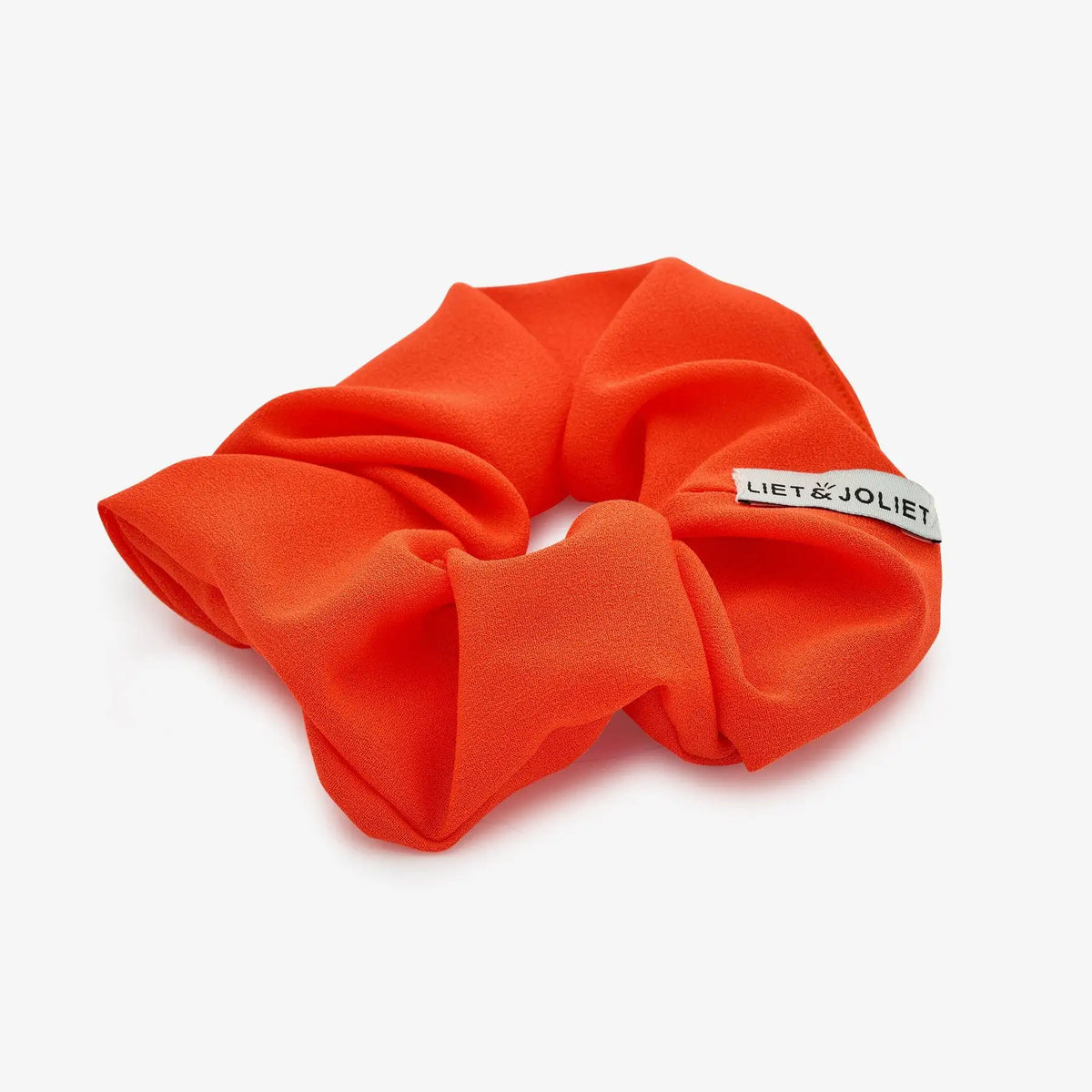 Red scrunchie with an elegant design for women and girls, perfect as a stylish everyday hair accessory
