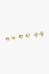 Set of gold heart-shaped earrings on a white background