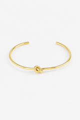 Stainless steel knot ring with a water-resistant gold-tone finish and elegant minimalist design
