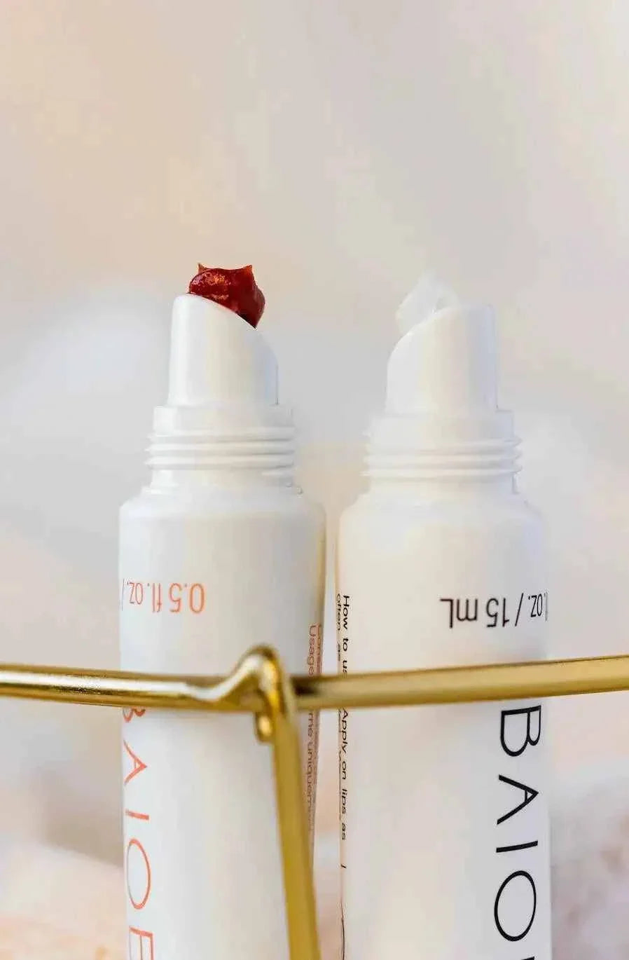 Baiobay Tinted LipBalm with white casing, featuring a soft translucent red ocher tinted balm and a clear balm stick