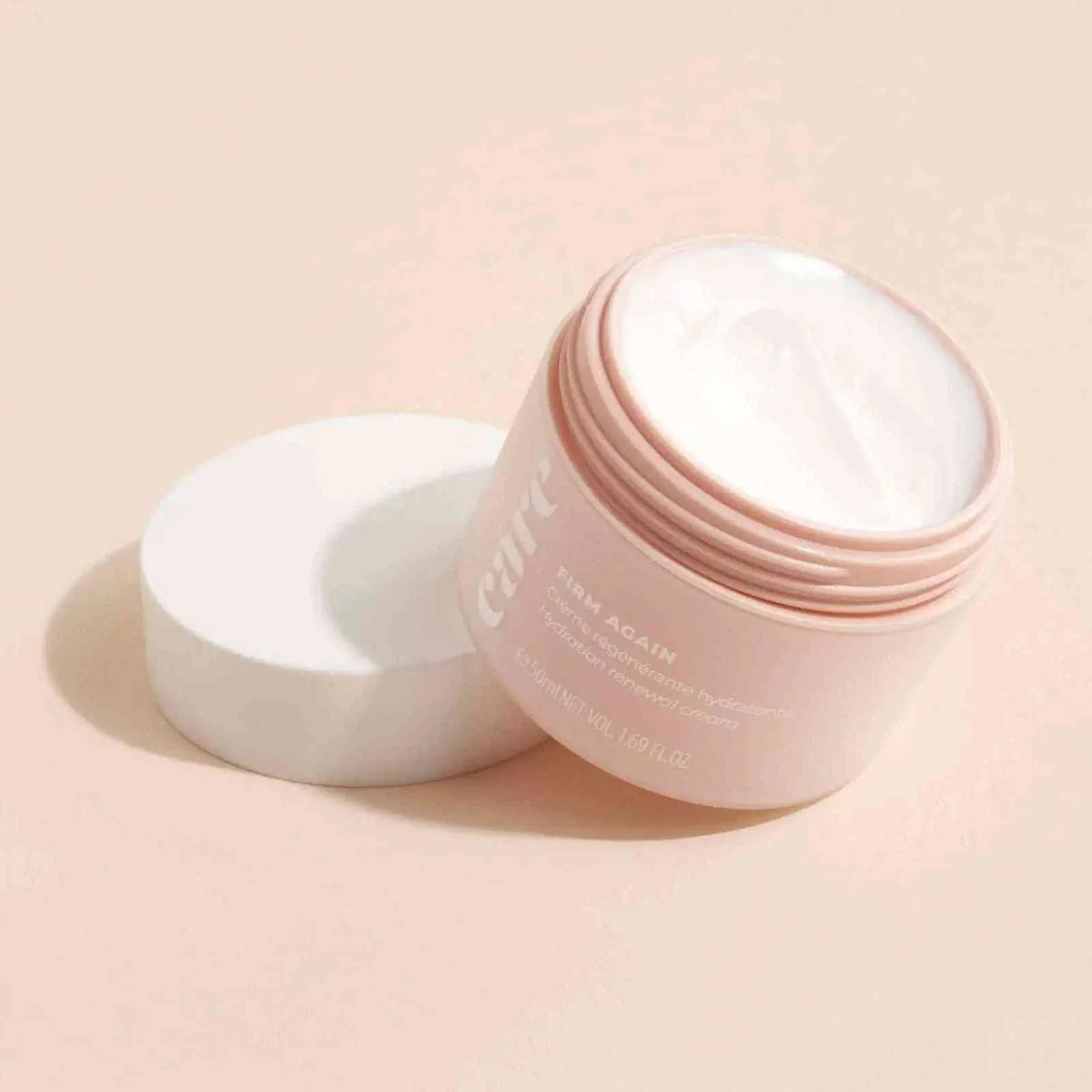 Care Firm hydration cream in a pastel pink jar with white lid, showing smooth white moisturizing cream inside