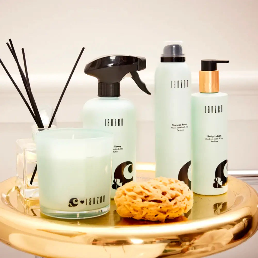 Janzen Room Spray &C Musk Jasmine & Joy, 500ml on a gold tray with candle and sponge.