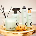 Janzen Room Spray &C Musk Jasmine & Joy, 500ml on a gold tray with candle and sponge.