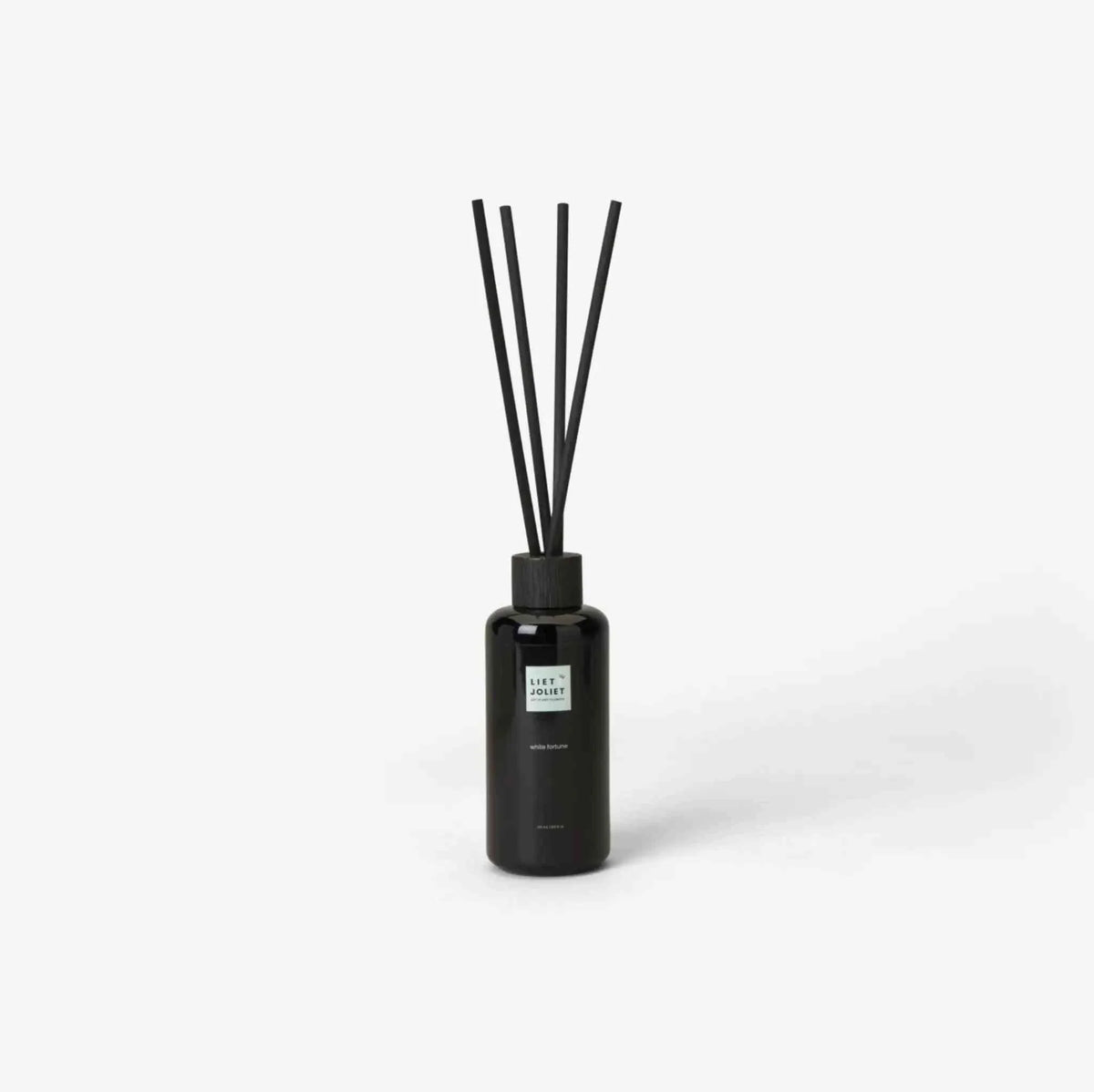 Liet & Joliet Fragrance Sticks White Fortune in sleek black glass bottle with tall black reed diffuser sticks