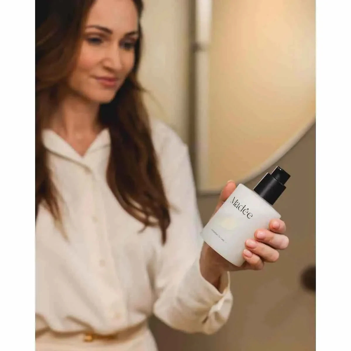 Madée Hand Soap Set featuring a frosted white bottle with black pump held by a woman wearing a cream blouse