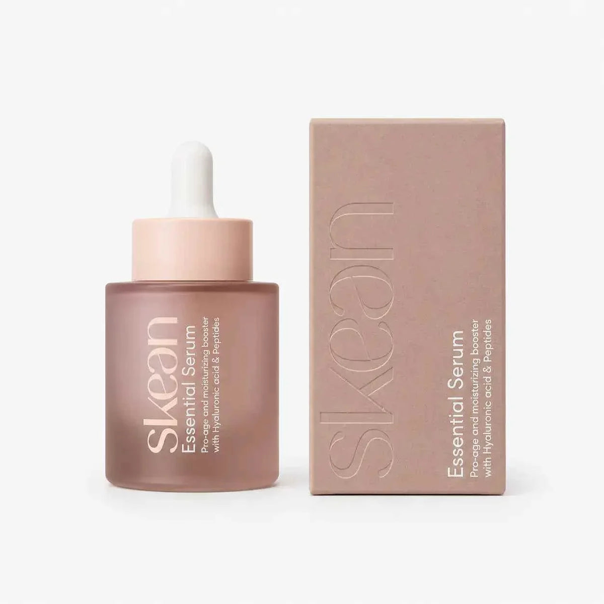 SkeanBeauty Essential Serum in a frosted pink glass dropper bottle with matching box, featuring minimalist white text branding