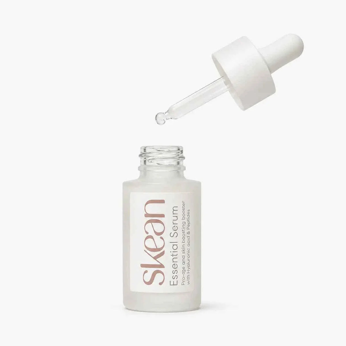 SkeanBeauty Essential Serum Travel in frosted glass bottle with white dropper cap dispensing clear serum drop