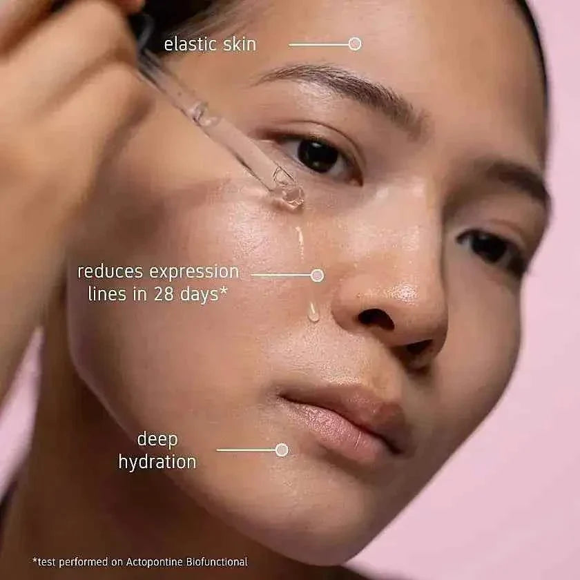 SkeanBeauty Essential Serum Travel applied with a dropper on smooth, hydrated skin highlighting elastic skin, reduced expression lines, and deep hydration benefits